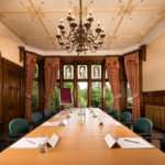Boardroom meeting room at Mercure Burton Upon Trent Newton Park Hotel, wood panels, chandelier, full length windows to grounds