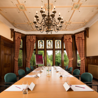 Boardroom meeting room at Mercure Burton Upon Trent Newton Park Hotel, wood panels, chandelier, full length windows to grounds