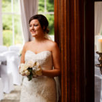Bride standing in the Conservatory at Mercure Burton Upon Trent Newton Park Hotel, wedding ceremony room