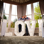 Newly married couple kissing in the Conservatory at Mercure Burton Upon Trent Newton Park Hotel