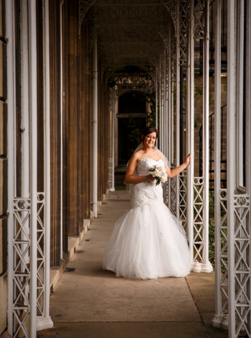 Bride standing in walkway in garden of Mercure Burton Upon Trent Newton Park Hotel